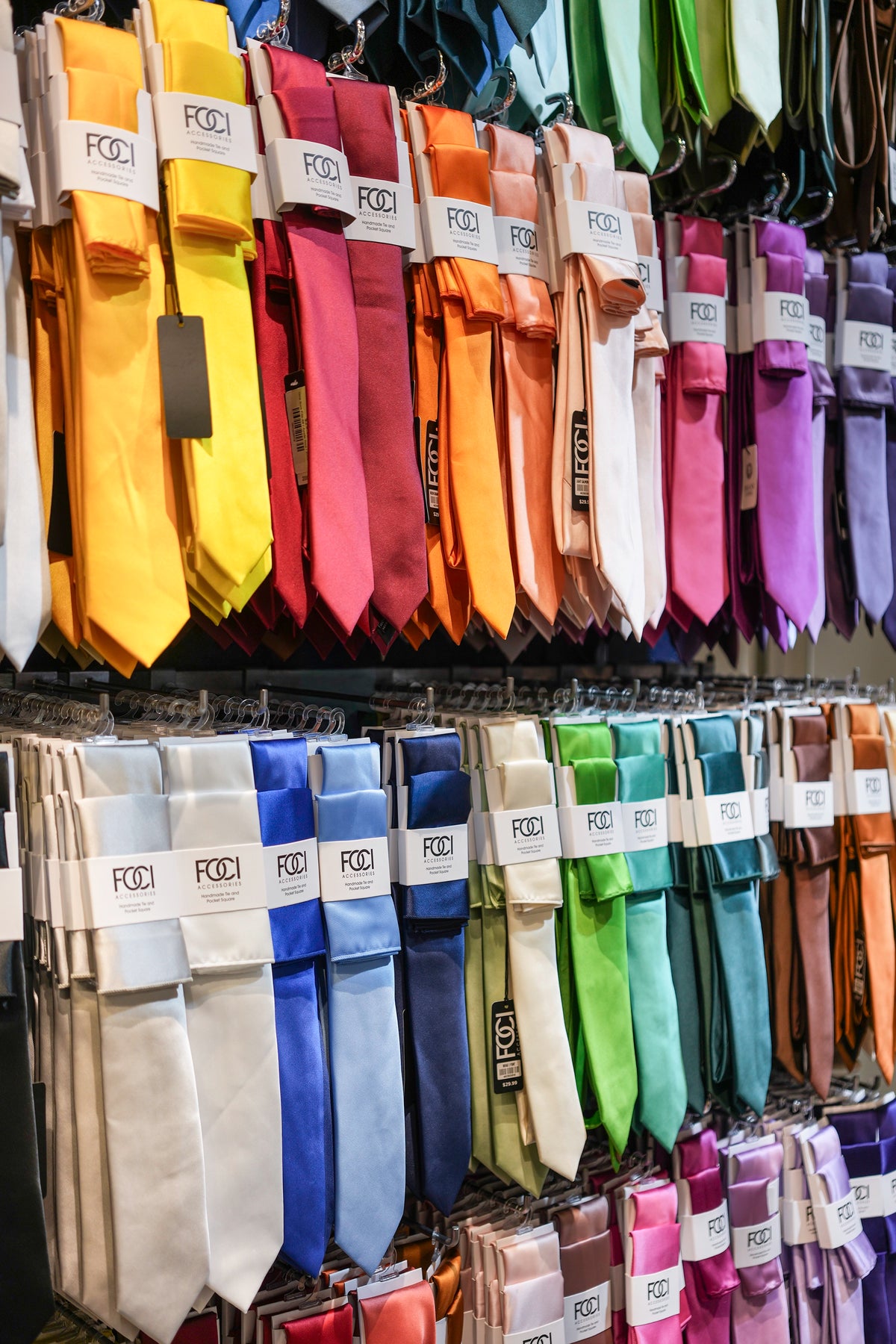 FOCI Neckties hanging on hooks in the Dolce Vesta store showing a variety of colors.