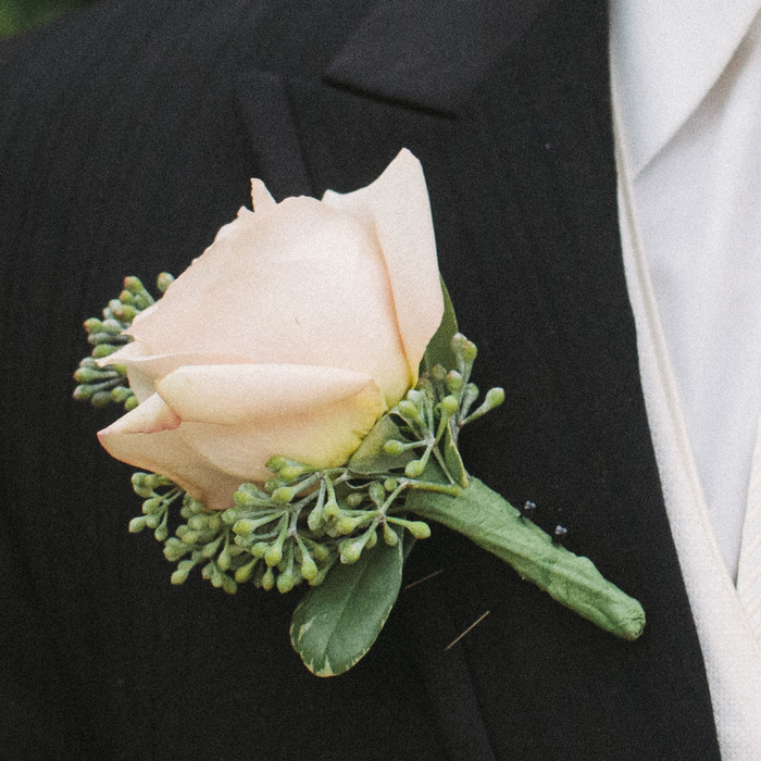 A Floral Boutonniere On A Tuxedo